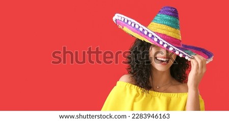 Beautiful happy woman in sombrero hat on red background with space for text