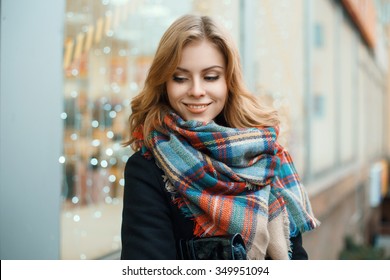 Beautiful happy woman with a vintage scarf on the background of blue lights