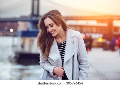 Beautiful Happy Woman Walking Near East River In New York City And Looking Down