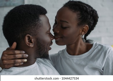 beautiful happy young african american couple able to kiss at home