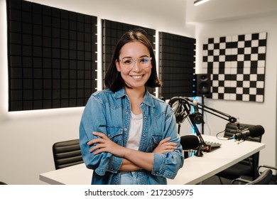 Beautiful Happy Young Female Radio Host Smiling While Broadcasting In Studio