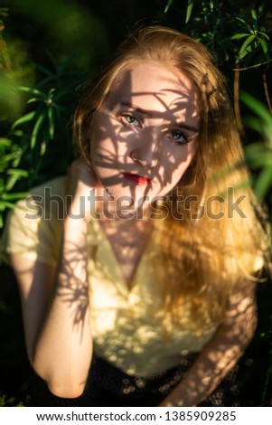 Similar – Portrait of smiling blonde woman with hat while she walks in nature looking into camera.