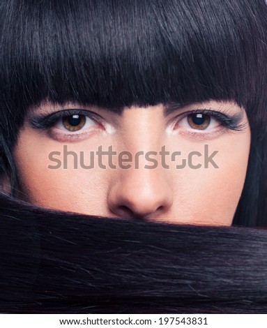 Beautiful and happy young girl holding hair in the face