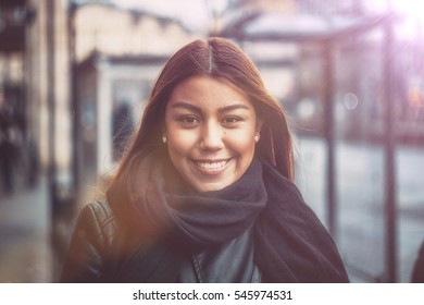 Beautiful Happy Young Hispanic Woman Walking In The Street In The Sunset - Sun-flare Photo