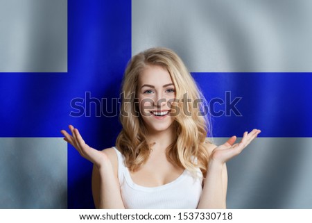 Beautiful happy young woman against the finnish flag background. Live, education and work in Finland