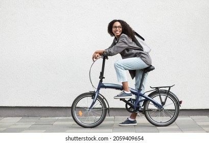 Beautiful happy young woman with bicycle on a city street. Active lifestyle, people, city life, having fun, enjoying life concept - Powered by Shutterstock