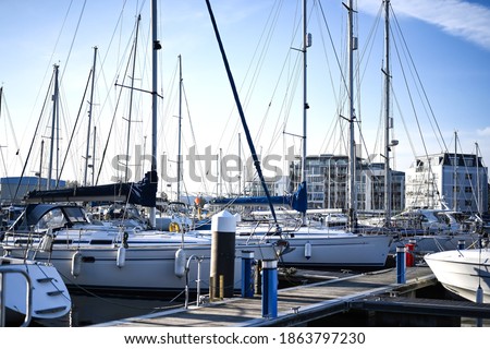 beautiful harbour view on a sunny day with many yachts and rigging