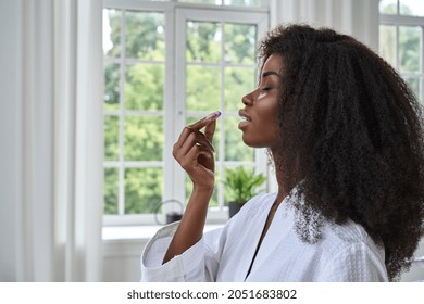 Beautiful Healthy Black African Young Woman Wearing Bathrobe Holding Vitamin Dietary Pill Taking Daily Morning Supplements Multivitamin Medicine For Women Beauty And Skin Health Care Concept.