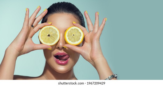 Beautiful healthy girl with slices of lemon citrus fruit, food, cosmetics. Healthy eating, diet. Beauty young fashion woman plays with lemons, organic vegetables. Vegetarian concept.