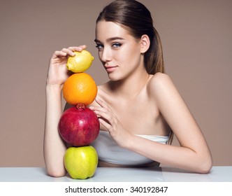 Beautiful And Healthy Skin, Natural Organic Raw Fresh Food Concept / Portrait Of Girl With Fruits Mix On The Table Over Beige Backdrop. High Resolution Product.