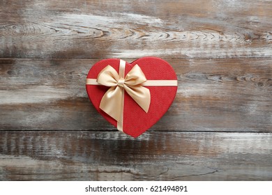 Beautiful heart gift box on a brown wooden table - Powered by Shutterstock