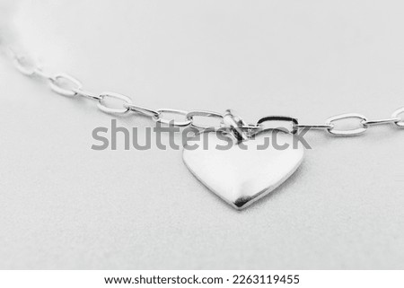 Beautiful heart shaped silver pendant on silver necklace