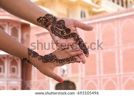 Beautiful henna Arabic design on Indian girls hands at City Palace on wedding in Rajasthan. Mehndi is still a popular form of body art among the women of  India, Pakistan, Africa