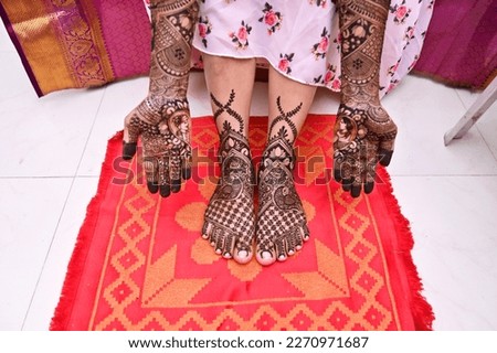 Beautiful henna art on hands and legs. Bridal design. Wedding Mehendi. Indian arabian culture of wedding mehendi