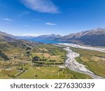 Beautiful high angle aerial view of Rees River, Dart River and the Glenorchy-Paradise Road with the town of Glenorchy and Lake Wakatipu in the background. Near Queenstown, South Island, New Zealand.