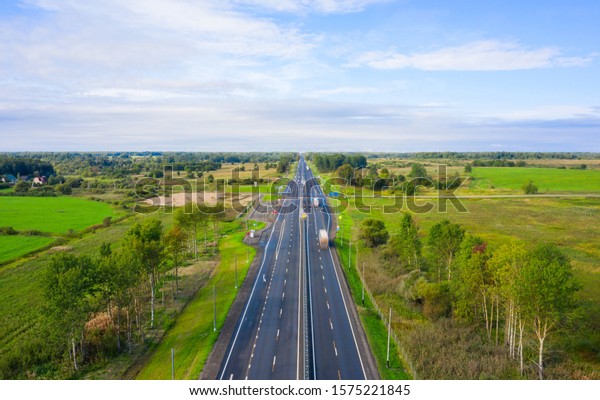 Beautiful hight way road on an early summer\
morning in central Russia. Moscow-Minsk M1 highway, Bird\'s eye view\
of the road and\
skyline.
