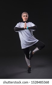 A Beautiful Hijab Muslim Girl Wearing Sport Outfit While Doing Exercise Pose And Body Stretching