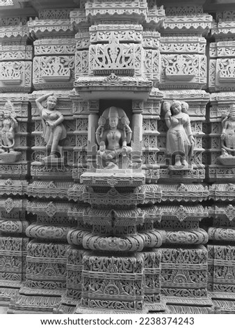 Beautiful HINDU INDIAN temple in India black and white photo. Ancient cultural temples have statues carved out of stones. 