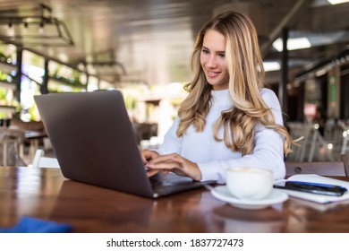 Beautiful Hipster Woman Using Laptop At Cafe