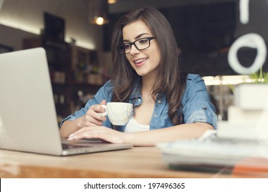 Beautiful Hipster Woman Using Laptop At Cafe