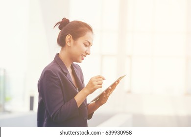 Beautiful Hipster Young Woman Wear White Lace Dress Using Ipad Or Smart Phone Whith Sitting Has Office Blur Background To Explore Website . Technology Concept
