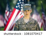 Beautiful Hispanic American soldier in Uniform standing in front of American flags