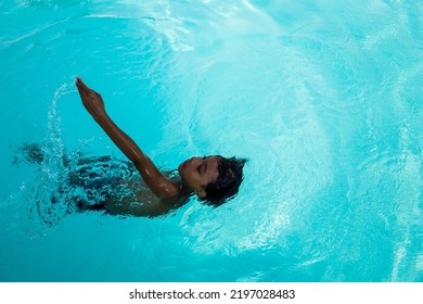 Beautiful Hispanic Boy Playing In An Outdoor Pool