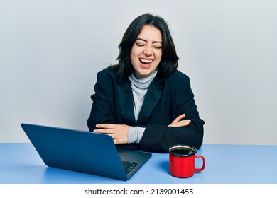 Beautiful Hispanic Business Woman With Arms Crossed Gesture At The Office Smiling And Laughing Hard Out Loud Because Funny Crazy Joke. 