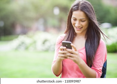 A beautiful hispanic college student texting on her cellphone