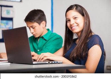 Beautiful Hispanic High School Student Using A Laptop In A Classroom