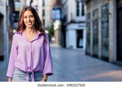 Beautiful Hispanic Independent Young Woman Lifestyle Urban Portrait. Lavender Streetwear Stylish Looking At Camera. Real People