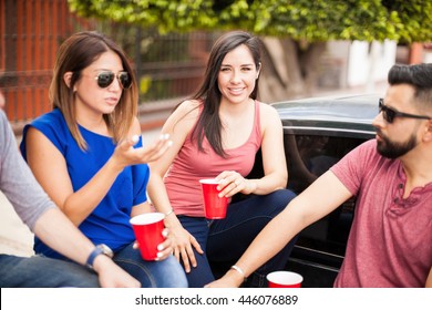 Beautiful Hispanic Woman Hanging Out With Family And Friends And Tailgating On A Sunday Game