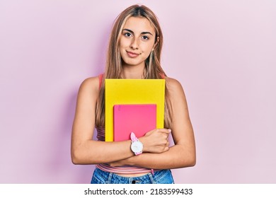 Beautiful Hispanic Woman Holding Books Thinking Attitude And Sober Expression Looking Self Confident 