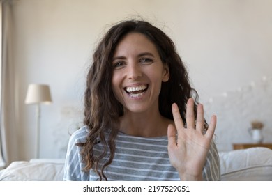 Beautiful Hispanic Woman Look At Camera Start Video Call, Wave Hand Greets Friend Or Family Living Abroad Enjoy Virtual Meeting, Remote Talk Using Modern Tech, Head Shot. Video Conference App Concept