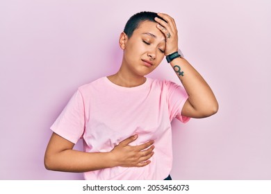 Beautiful Hispanic Woman With Short Hair Wearing Casual Pink T Shirt Touching Forehead For Illness And Fever, Flu And Cold, Virus Sick 