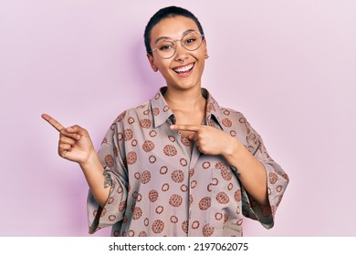 Beautiful Hispanic Woman With Short Hair Wearing Glasses Smiling And Looking At The Camera Pointing With Two Hands And Fingers To The Side. 