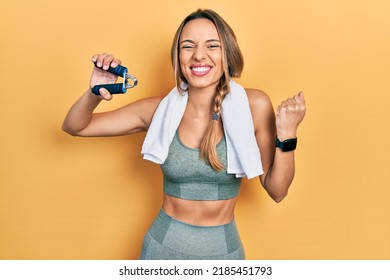 Beautiful hispanic woman training muscle with hand grip screaming proud, celebrating victory and success very excited with raised arm  - Shutterstock ID 2185451793