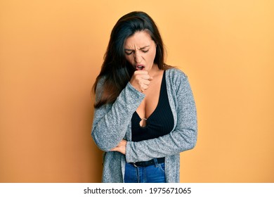 Beautiful hispanic woman wearing casual clothes feeling unwell and coughing as symptom for cold or bronchitis. health care concept.  - Shutterstock ID 1975671065