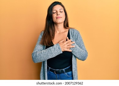 Beautiful Hispanic Woman Wearing Casual Clothes Smiling With Hands On Chest, Eyes Closed With Grateful Gesture On Face. Health Concept. 