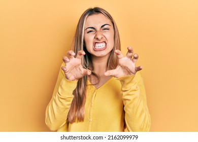 Beautiful Hispanic Woman Wearing Casual Yellow Sweater Smiling Funny Doing Claw Gesture As Cat, Aggressive And Sexy Expression 