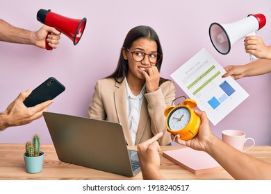 Beautiful Hispanic Woman Working At The Office Under Stress Looking Stressed And Nervous With Hands On Mouth Biting Nails. Anxiety Problem. 