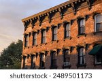 beautiful historic brick buildings in downtown hudson new york at sunset (golden hour glow at dusk night sun set) warren street valley upstate (brownstone homes, business district main)