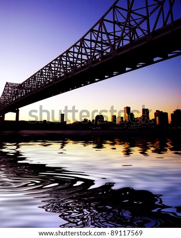 Beautiful historical Crescent City Connection Bridge in New Orleans Louisiana. Skyline, cityscape with reflection in water.
