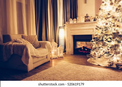 Beautiful Holiday Decorated Room With Christmas Tree, Armchair And Fireplace At Night. Led Lighting, Cozy Home Scene. Nobody There.