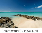 Beautiful holiday destination of Antigua, with white beach in Jolly Harbour, Antigua and Barbuda, with sunny day, blue skies and turquoise waters