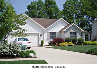 Beautiful Home In An American Suburban Neighborhood - Car In Driveway.