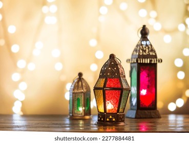 Beautiful home decor ideas with vintage style lanterns or candle holders. Illuminated Islamic lanterns against xmas lights blur background.  Festive objects and home accessories. - Powered by Shutterstock