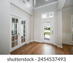 Beautiful home entryway with office doors