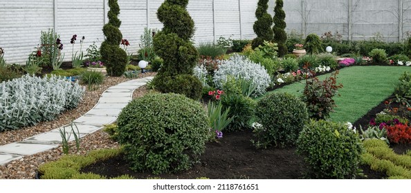 Beautiful home landscaped garden. Landscape design of backyard. Nice landscaping with cozy arbor, concept of house rest and nature.Beautiful flower garden. Landscaping flower garden. Selective focus.