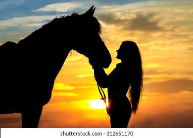 Beautiful Horse With Girl Silhouette On Sunset